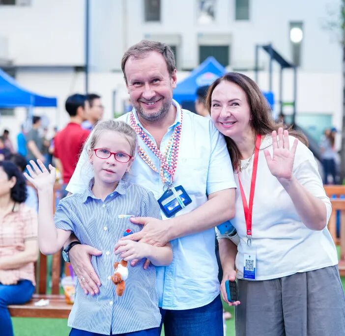 Families sharing food and laughter at Welcome BBQ