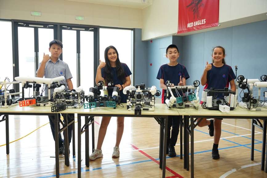 YCIS Beijing students with their underwater robotics projects at competition table