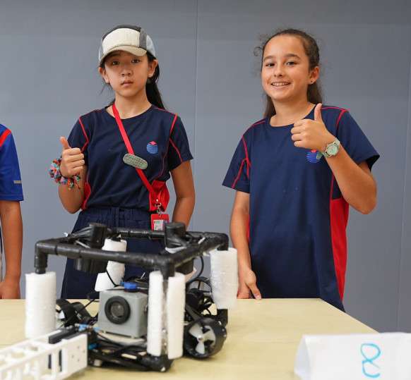 Students showcasing their award-winning underwater robot design