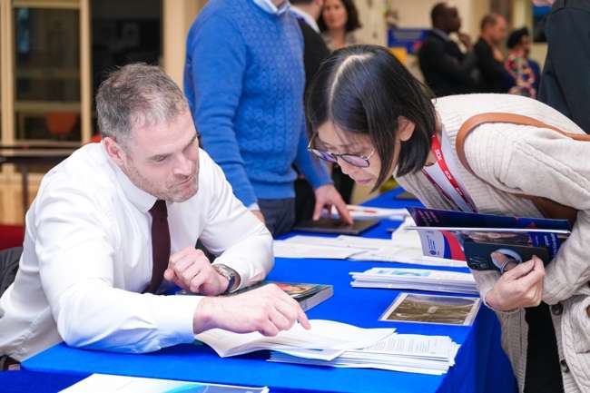 Parents and students reviewing academic programme materials