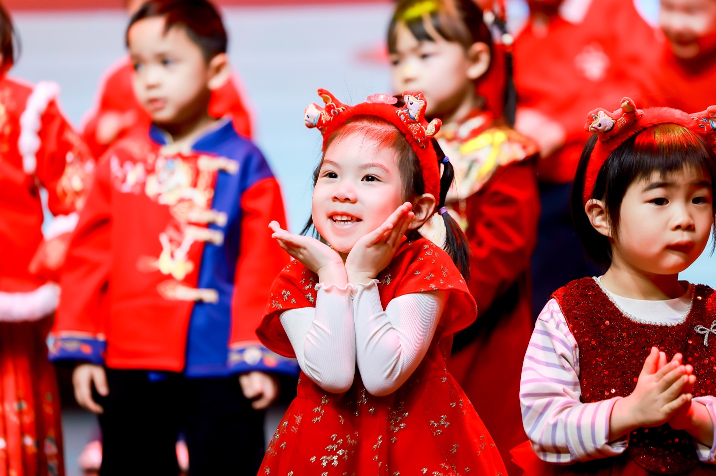 Children in traditional red dresses