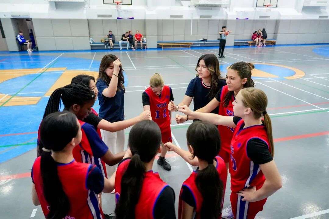 Student coaches mentoring younger players at YCIS Beijing